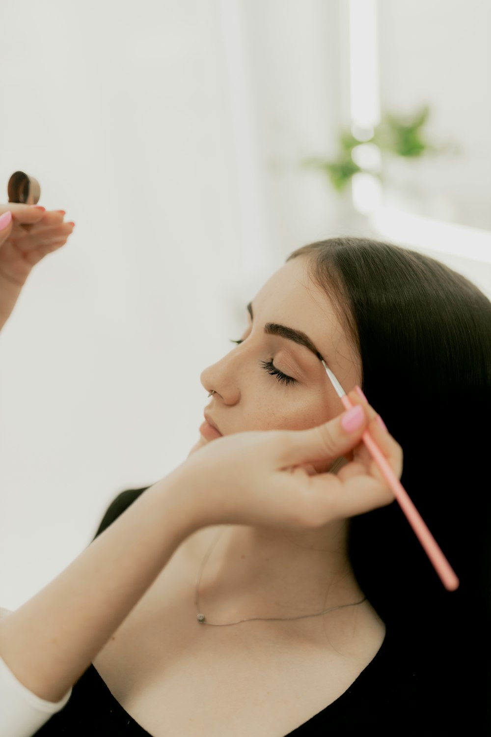 Brows being shaped with a brush